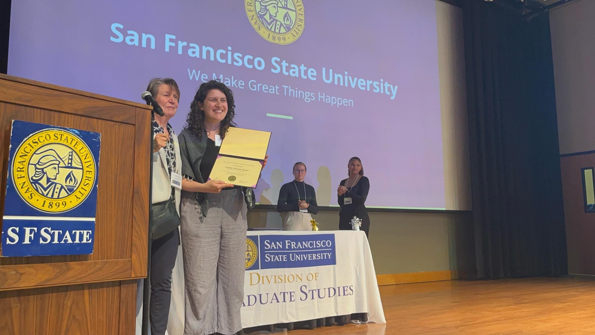 Graduate student Taylor Stone receiving an award